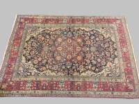 Lot 540 - A Persian style floral decorated red and ivory ground rug