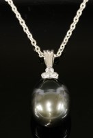 Lot 554 - A white gold Tahitian cultured pearl and diamond pendant