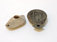 Lot 108 - A pottery oil lamp