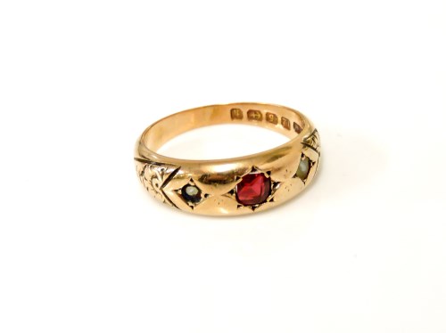 Lot 10 - A 12ct gold red stone possibly garnet and split pearl ring