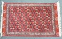 Lot 569A - A fuschia ground carpet