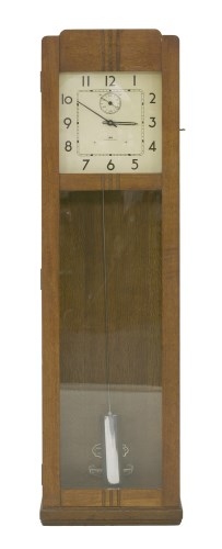 Lot 141 - An Art Deco oak longcase clock