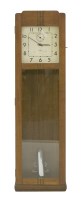 Lot 141 - An Art Deco oak longcase clock