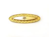 Lot 28 - A Victorian gold Etruscan style oval single stone diamond brooch
