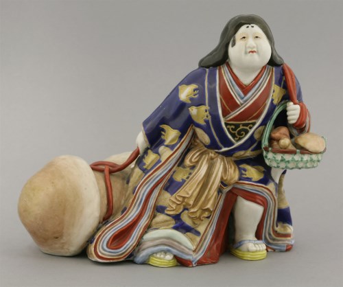 Lot 275 - An Imari figure of Okame