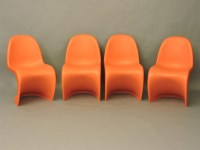 Lot 476 - A set of four Vitra moulded orange plastic chairs