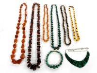 Lot 46 - Three single rows of graduating free form amber beads