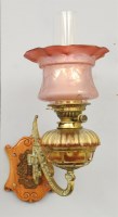 Lot 149 - A brass mounted wall oil lamp