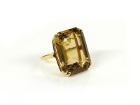 Lot 8 - A gold emerald cut smokey quartz ring