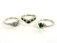 Lot 14 - A 9ct white gold three stone sapphire and diamond ring