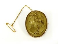 Lot 44 - A gold lava stone carved cameo brooch