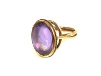 Lot 8 - A Continental low carat single stone amethyst cabochon ring