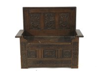 Lot 516 - An oak monks bench with carved detailing