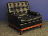 Lot 546 - A retro arm chair upholstered in faux black leather