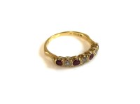 Lot 65 - A seven stone ruby and diamond half eternity ring
