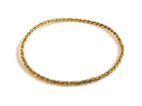 Lot 58 - A gold twisted rope slave bangle