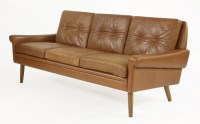 Lot 372 - A tan leather three-seater settee