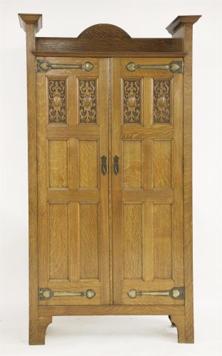 Lot 52 - An Arts and Crafts oak hall cupboard