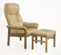Lot 403 - A tan leather armchair and matching ottoman