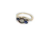 Lot 7 - A gold diamond and sapphire three stone crossover ring