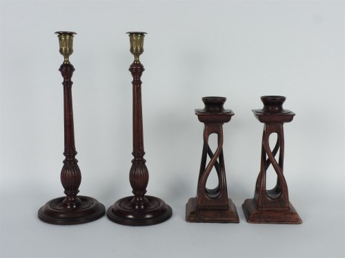 Lot 315 - Two pairs of wooden candlesticks