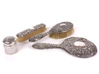 Lot 111 - A hallmarked silver 3 piece dressing set with embossed decoration