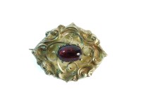 Lot 26 - A Victorian gold cased single stone foil backed garnet brooch