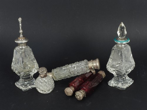 Lot 99 - Three glass and silver double ended scent bottles with silver caps