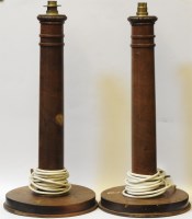 Lot 495 - A pair of turned mahogany table lamps on circular legs