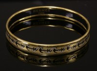 Lot 1005 - An Hermès narrow gold ground enamel gold plated bangle