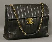 Lot 1254 - A Chanel black lambskin leather 'Mademoiselle' classic jumbo flap bag