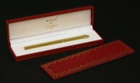 Lot 1038 - A Cartier gold-plated 'Vendome' ball pen