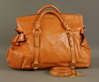 Lot 1296 - A Miu Miu orange calfskin leather Vitello Lux bow fold-over satchel bag