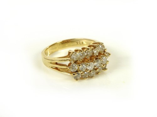 Lot 65 - A gold three row diamond cluster ring