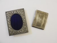 Lot 101 - A small silver photograph frame with a scrolling leaf decoration