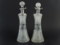Lot 394 - A pair of cut glass decanters with silver collars