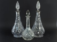 Lot 397 - A pair of cut glass decanters with silver collars and one other decanter (3)