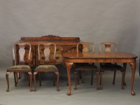 Lot 581 - An early 20th century walnut dining room suite