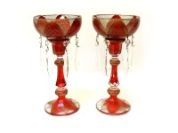 Lot 139 - A pair of ruby and gilt candlesticks