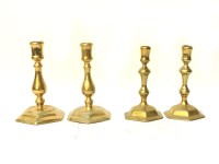 Lot 262 - Two pairs of Queen Anne style brass candlesticks