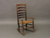 Lot 623 - An elm and ash ladderback rocking chair