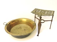 Lot 254 - An antique brass trivet and a bowl with ring handles