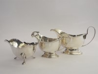 Lot 180 - Three hallmarked silver sauce boats each with scroll handles