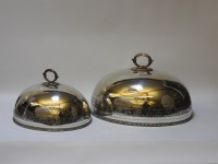 Lot 283 - A graduated pair of Victorian silver plated meat covers