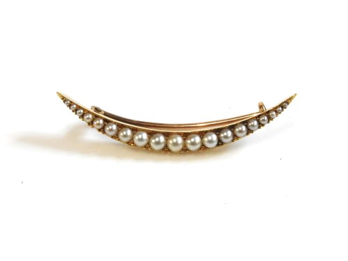 Lot 59 - A gold split pearl crescent brooch