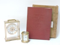 Lot 201 - A miniature brass oval carriage clock