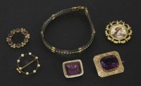 Lot 113 - A rolled gold brooch with purple paste stone