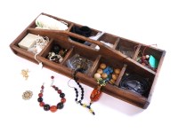 Lot 187 - A rustic wooden tray of assorted loose beads and jewellery