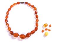 Lot 203 - A short row of faceted amber beads