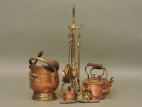 Lot 555 - A Victorian brass and copper fireside companion set